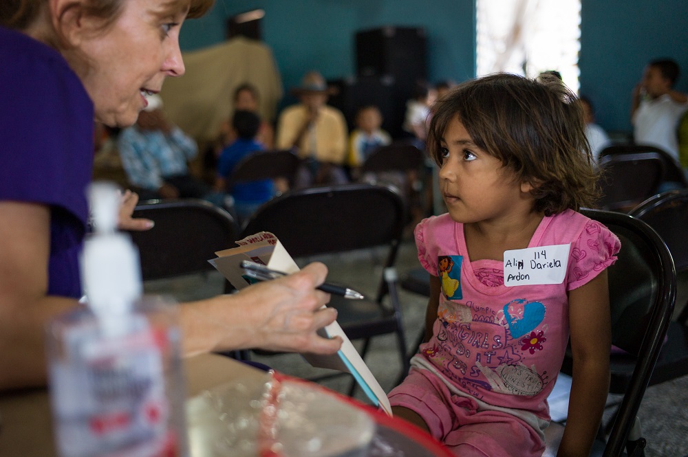 Volunteer worker with little girl